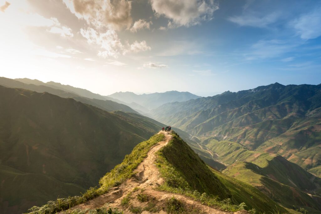 Breathtaking view of a mountain trail under a vibrant sunrise, showcasing natural beauty.
